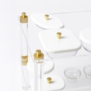 Acrylic trolley-Acrylic serving cart with three shelves and gold accents, white lidded plates.